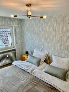 a bedroom with a large bed with two pillows at RelaxStay - Balkon - Smart-TV - WIFI in Dielheim