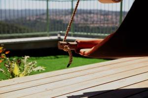 a person is holding a chain on a balcony at בקתת מרווה in Abirim