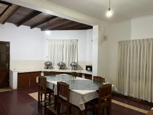 a kitchen with a table and chairs in a room at The Green Savanna Holiday Bungalow Nuwara Eliya in Nuwara Eliya