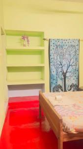 a room with a bed and a red rug at Elara Beach View HomeStay in Alleppey