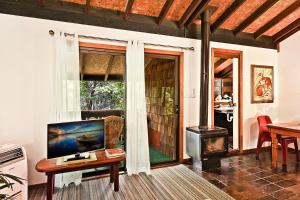 a living room with a television and a fireplace at Salisbury Lodges in Salisbury