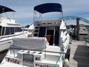 a white boat is docked at a dock at Yacht Stay Providence Marina in Providence