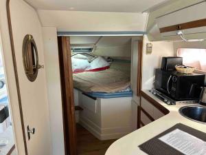 a small room with a bed and a sink at Yacht Stay Providence Marina in Providence