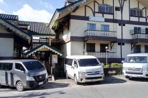 três veículos estacionados em frente a um edifício em 5 Bedrooms 4 Bath/toilet & Mountain View Fast Net em Baguio