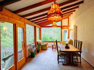 a dining room with a table and a chandelier at Villa Forest Paradise in Ohrid