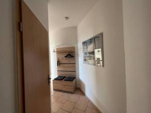 a hallway with a door to a room with a closet at Traumwohnung am Altstadt Hafen Stralsund in Stralsund