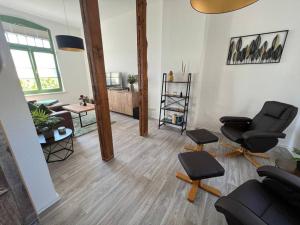 a living room with two chairs and a couch at Traumwohnung am Altstadt Hafen Stralsund in Stralsund
