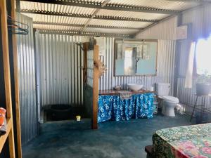 a room with a bathroom with a sink and a toilet at L'Arche in Rodrigues Island