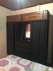 a bedroom with a bed with a black cabinet at Casa en Atenas, entorno tranquilo in Atenas