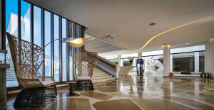 a lobby with escalators and a staircase in a building at Elma Hotel and Art Complex in Zikhron Ya'akov +37 photos