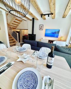 a dining room with a table with a bottle of wine at Laura's Haus with Parking in Tudela