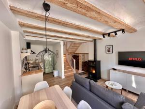 a living room with a couch and a table and a fireplace at Laura's Haus in Tudela