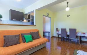 a living room with an orange couch and a table at Nice Apartment In Marcana With Wifi in Marčana
