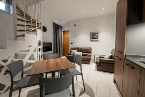 a kitchen and living room with a table and chairs at Marea Central Apartments in Sliema