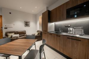 a kitchen and dining room with a table and chairs at Marea Central Apartments in Sliema