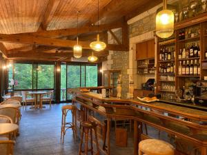 a bar in a restaurant with tables and chairs at L'AUBERGE DE LA GOUTILLE in Capvern