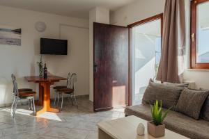a living room with a couch and a table at APARTMANI JAMAN in Vrsi