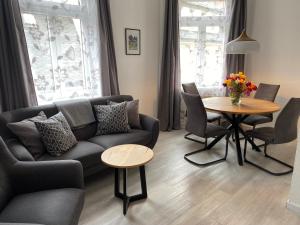 a living room with a couch and a table at Apartmenthaus Zentral Bad Schandau in Bad Schandau