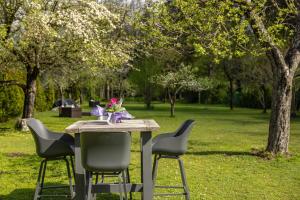 a table with chairs and a vase of flowers on it at FACT Apartments in Arnoldstein