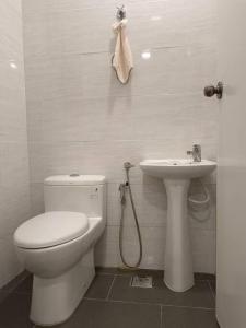 a bathroom with a toilet and a sink at Guesthouse 26 Villa/Sejati/Mile7 in Sandakan