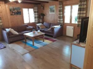 a living room with couches and a coffee table at Les loulou in Savièse