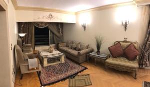sala de estar con sofá, sillas y mesa en كورنيش النيل المعادي ابراج الجوهرة Nile Edge, en El Cairo
