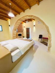 a bedroom with a large bed in a stone archway at Tafileh-Sila'a Heritage Village in At-Tafilah