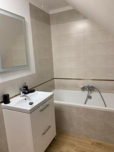 a bathroom with a sink and a bath tub at Dom na Mazurach in Stare Juchy