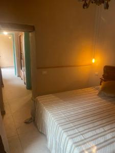 A bed or beds in a room at Corte Boero Bed&Breakfast
