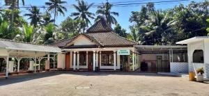 an old building with a tile roof at Dam Ri Private 2nd Floor - Near Airport & Batukaras in Tjidjulang +53 photos