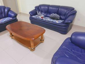 a living room with a couch and a coffee table at IJM Homestay Condominium in Sandakan