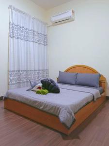 a bedroom with a bed with a stuffed animal on it at IJM Homestay Condominium in Sandakan