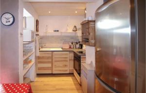 una pequeña cocina con nevera de acero inoxidable en Nice Apartment In Vals Les Bains, en Vals-les-Bains