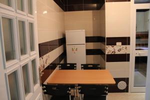 a kitchen with a table with chairs and a refrigerator at LE JASMIN RESIDENCE bord de mer in Hammam Sousse +9 photos
