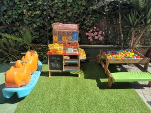 a pretend play area with toys on the grass at Apartamento en playa arenal de Burriana in Burriana