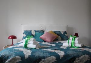 a bed with two stuffed animals on top of it at Albadamar Terrace in Trani