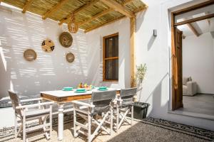 a dining room with a table and chairs at Pera houses 2-bedroom in the center of Lindos in Líndos