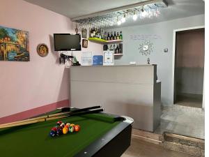a room with a pool table and a bar at Guest House Paskal in Balchik