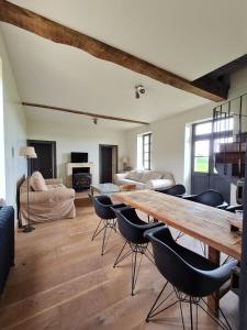 - un salon avec une grande table et des chaises en bois dans l'établissement Château de Paraize, à Livry