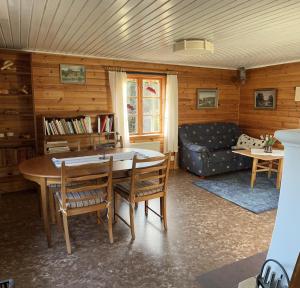 a living room with a table and a couch at Runeholm in Vimmerby