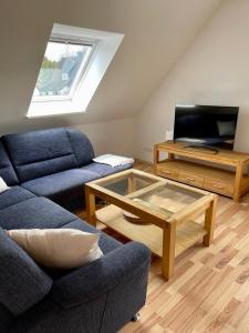 a living room with a couch and a coffee table at Ferienwohnung Friedrich Dorfmark in Bad Fallingbostel