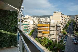 a view from a balcony of a city with buildings at Reunion in Greece Apartment in Athens