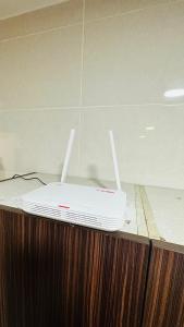 a white router sitting on top of a counter at Vista Alam Roomstay Homestay in Shah Alam