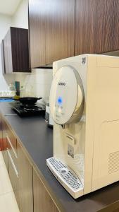 a kitchen with a machine on a counter at Vista Alam Roomstay Homestay in Shah Alam