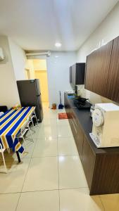 a kitchen with a counter and a table in it at Vista Alam Roomstay Homestay in Shah Alam