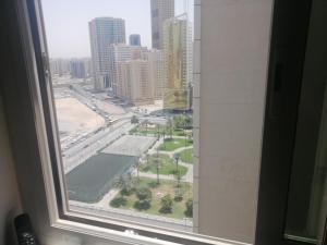 a view of a city from a window in a hotel at serene luxury master bedroom in Sharjah