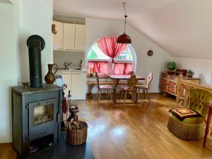 a living room with a stove and a dining room at Sokograd Attic in Šipovo