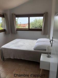 a bedroom with a large bed and a window at Petite Maison de Charme in Vence