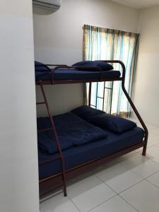 two bunk beds in a room with a window at AZ HomeStay Bandar Puncak Alam in Bandar Puncak Alam