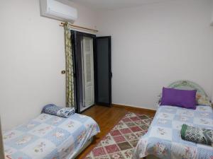 a room with a bed and a window and a bed and a pillow at شقة فندقية علي البحر مباشرة بجليم in Alexandria